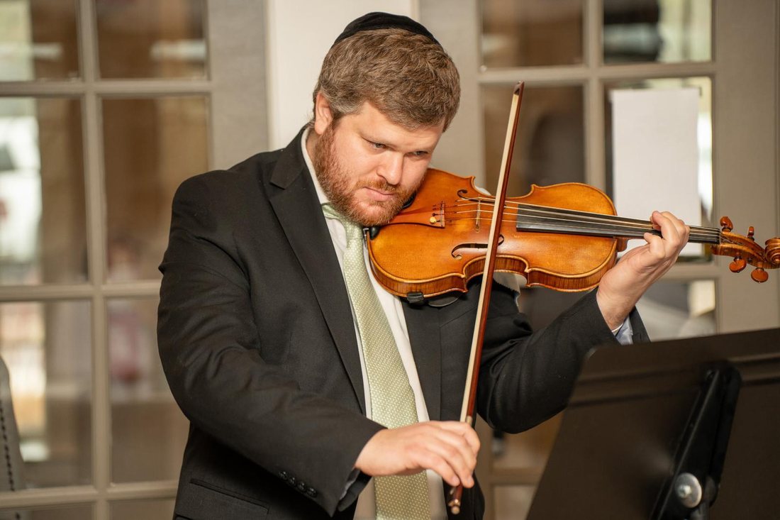 Dr. Yonatan Grinberg playing the violin